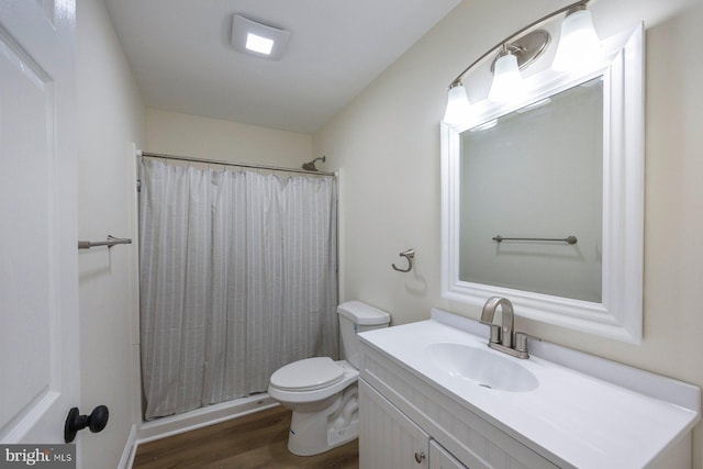 bathroom with a shower with shower curtain, vanity, toilet, and hardwood / wood-style floors