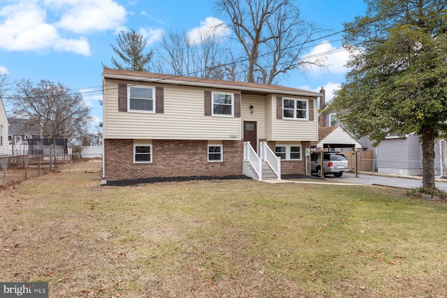 split foyer home with a carport and a front lawn