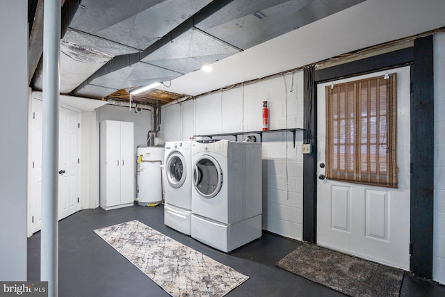 laundry room featuring gas water heater and washing machine and clothes dryer