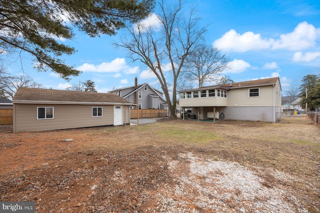 rear view of property featuring a sunroom