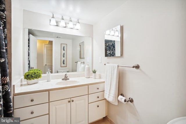 bathroom featuring vanity and toilet