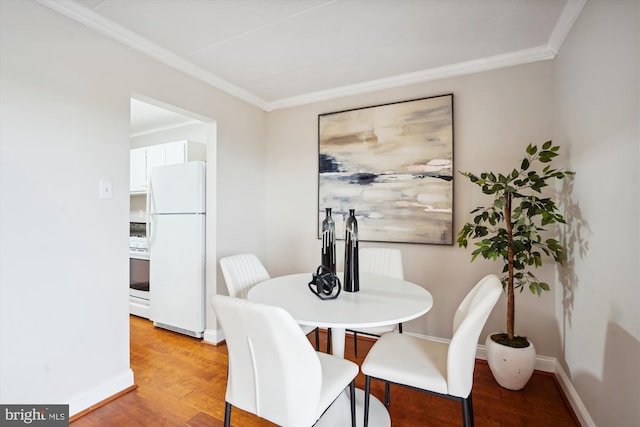 dining room with hardwood / wood-style floors and ornamental molding