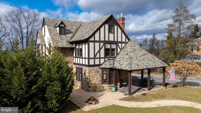 back of property with a yard and a patio area