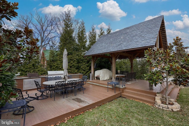 wooden deck featuring a grill and an outdoor kitchen