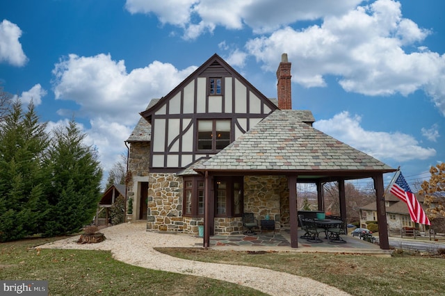 rear view of house with a patio area and a lawn