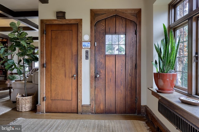 foyer entrance featuring radiator and light hardwood / wood-style floors