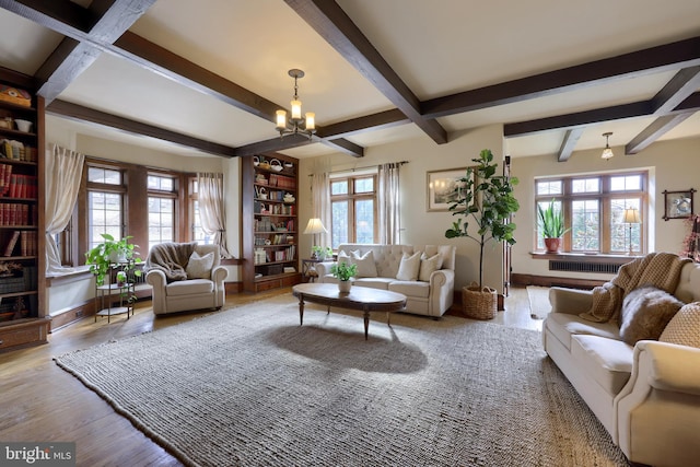 living room featuring beamed ceiling, wood-type flooring, and a chandelier