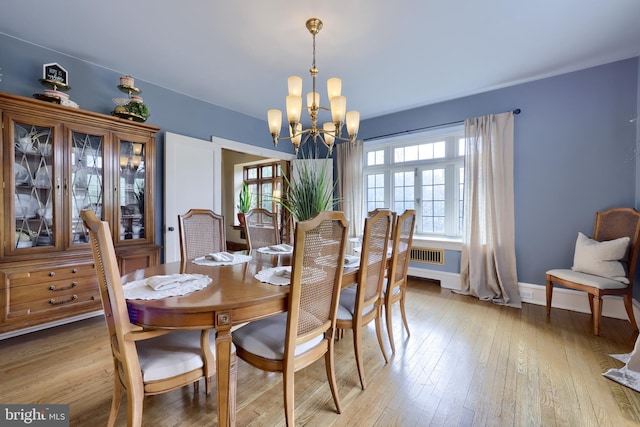 dining space with an inviting chandelier and light wood-type flooring