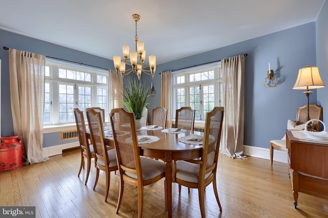 dining area with a wealth of natural light, light hardwood / wood-style flooring, and french doors