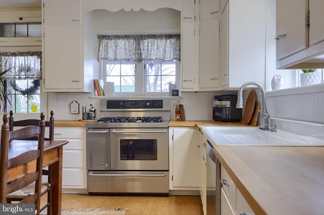 kitchen with white cabinetry, double oven range, and a healthy amount of sunlight