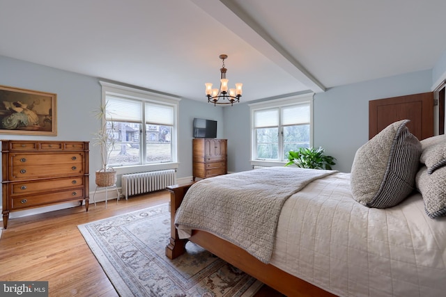 bedroom featuring an inviting chandelier, radiator heating unit, beam ceiling, and light hardwood / wood-style flooring