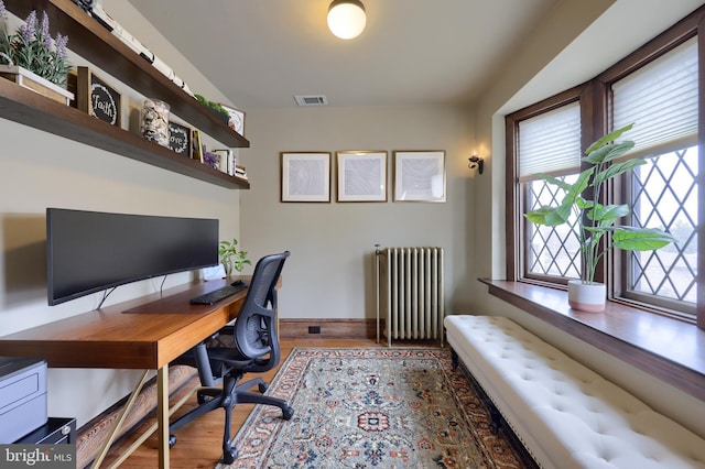 office space with radiator heating unit and dark hardwood / wood-style floors