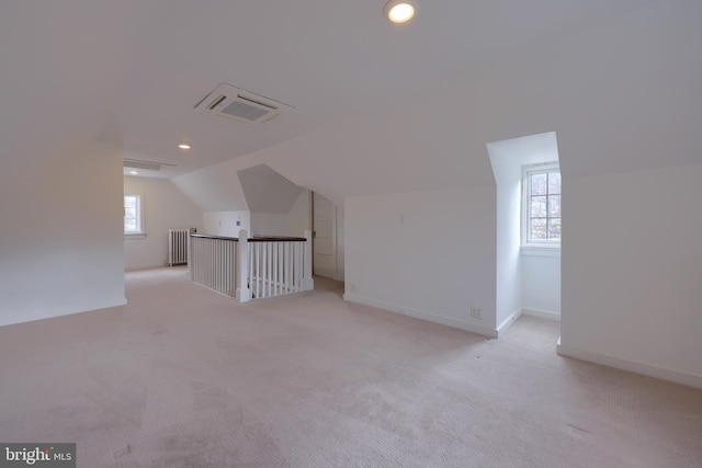 bonus room featuring light colored carpet and lofted ceiling