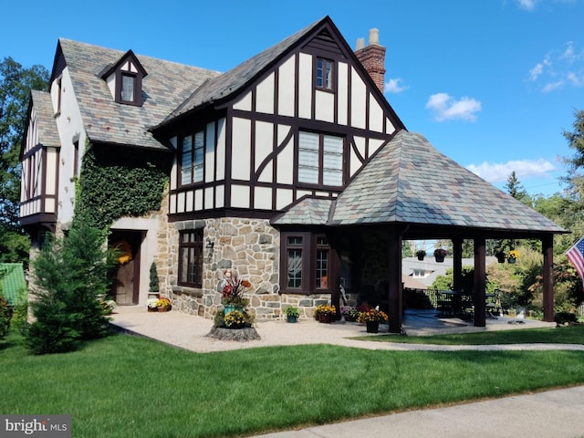 back of property with a gazebo, a patio, and a lawn