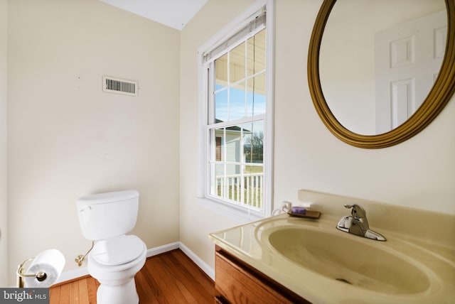 bathroom featuring vanity, toilet, and wood-type flooring