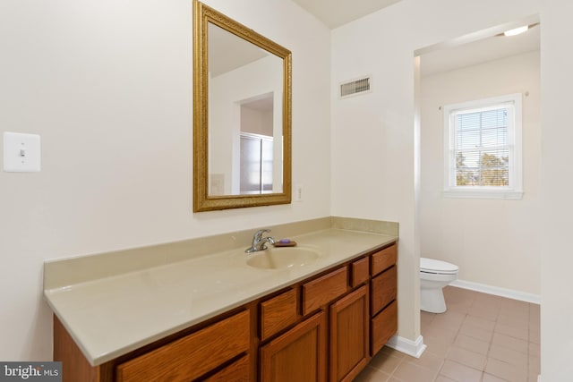 bathroom featuring vanity, tile patterned floors, and toilet