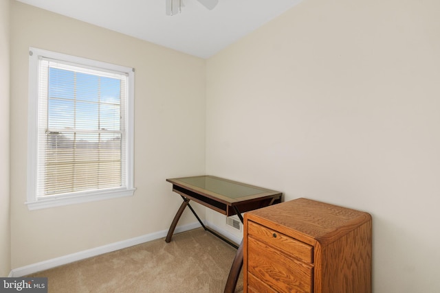 carpeted office featuring ceiling fan