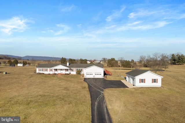 drone / aerial view featuring a mountain view and a rural view