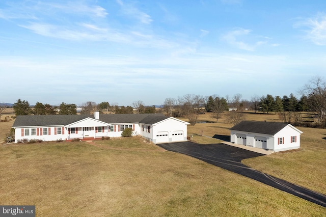 view of front of house featuring a garage, a front yard, and covered porch