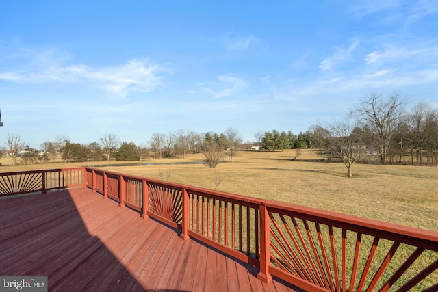 deck featuring a rural view and a yard