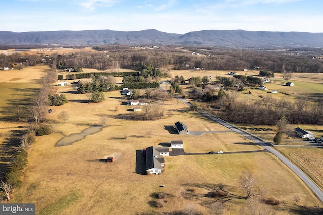 birds eye view of property with a mountain view and a rural view