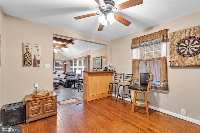 interior space featuring wood-type flooring, lofted ceiling, and ceiling fan