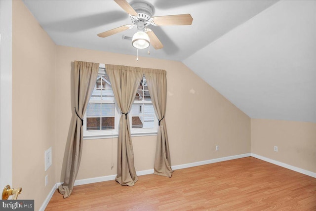 additional living space with hardwood / wood-style flooring, vaulted ceiling, and ceiling fan