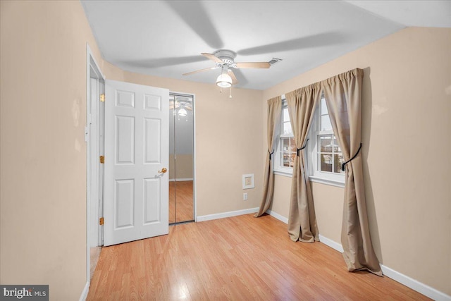 unfurnished bedroom featuring lofted ceiling, light hardwood / wood-style floors, and ceiling fan