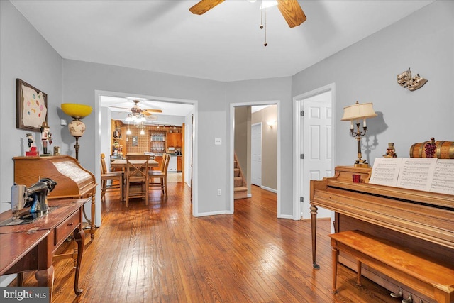 misc room featuring wood-type flooring and ceiling fan