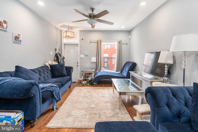 living room with ceiling fan and light wood-type flooring