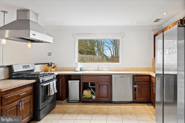 kitchen featuring light tile patterned floors, island range hood, stainless steel appliances, visible vents, and light countertops