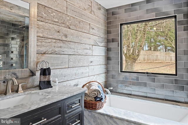 full bathroom featuring a bath and vanity