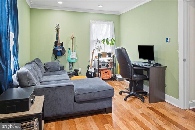 office area with ornamental molding, light wood-style flooring, and baseboards