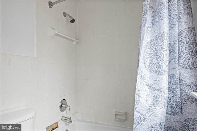 bathroom featuring shower / bath combo and toilet