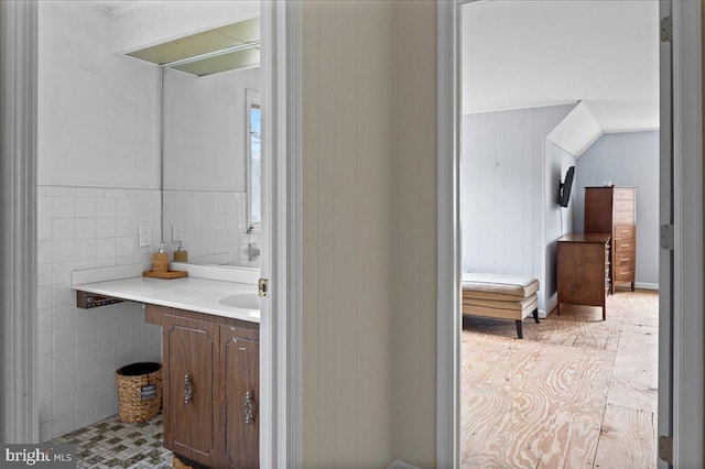 bathroom featuring tile walls and vanity