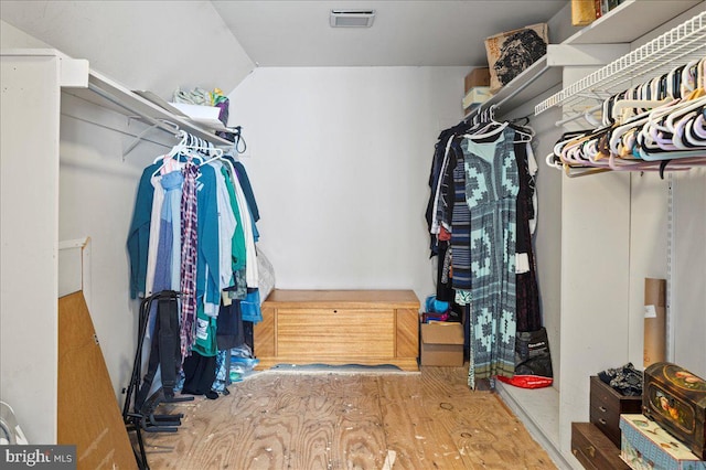 walk in closet with visible vents and vaulted ceiling