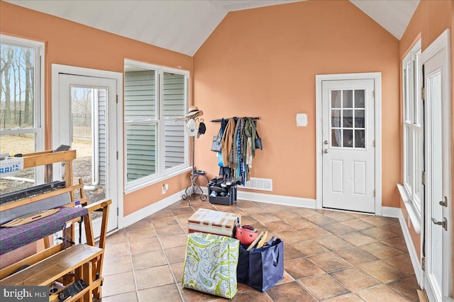 entryway featuring visible vents, vaulted ceiling, baseboards, and tile patterned floors