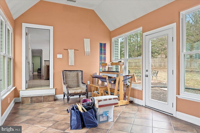 sunroom featuring visible vents and vaulted ceiling