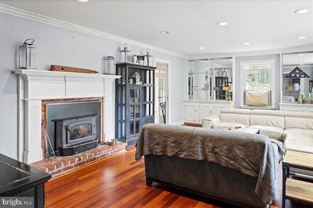 bedroom with ornamental molding, recessed lighting, wood-type flooring, and a wood stove