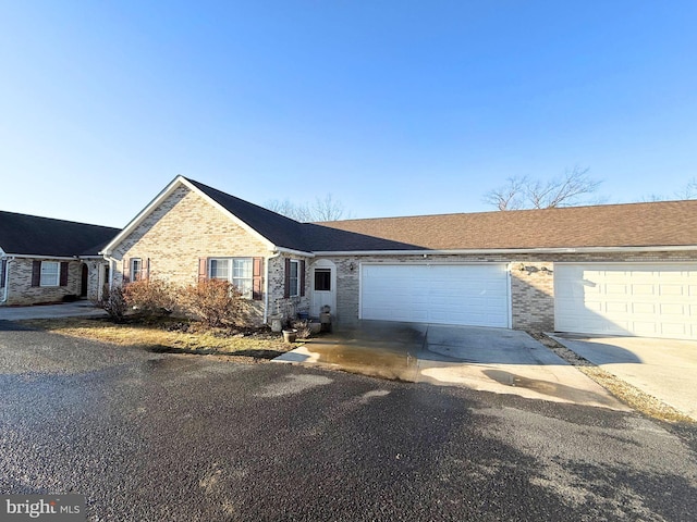 ranch-style home with brick siding, driveway, and an attached garage