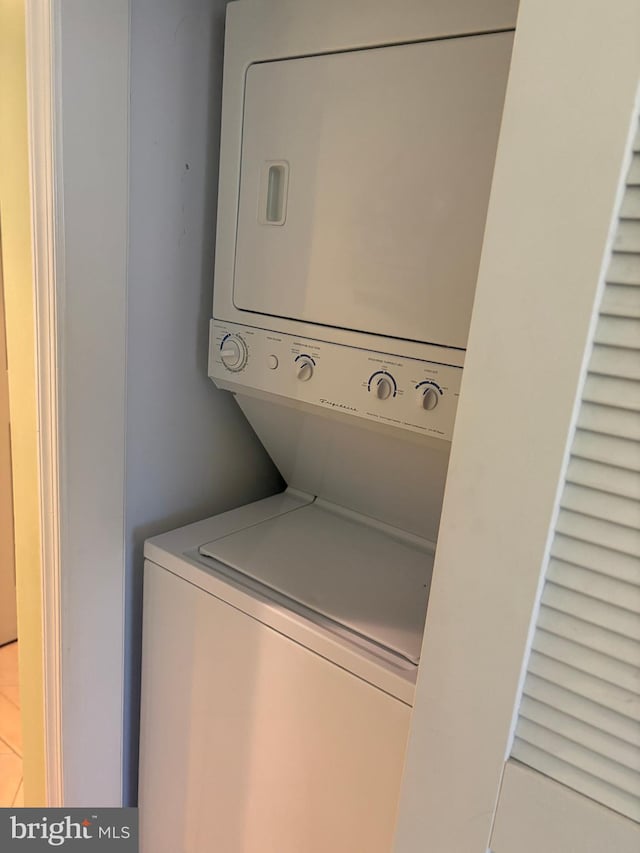 laundry area with stacked washer and clothes dryer