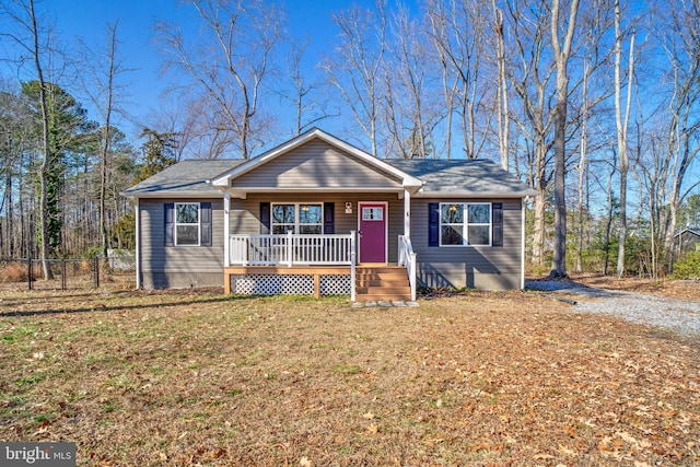 view of front of home with a porch and a front yard