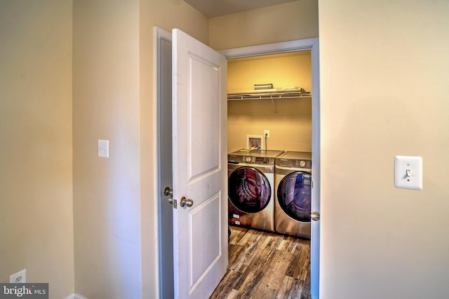 laundry area with dark hardwood / wood-style floors and separate washer and dryer