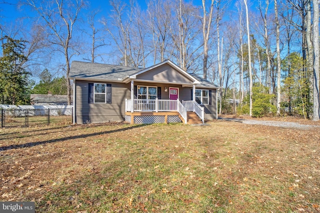 ranch-style house featuring a front lawn and covered porch