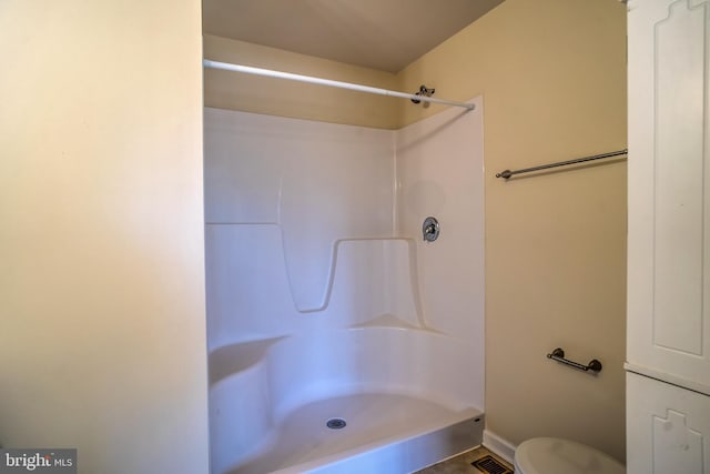 bathroom with toilet and a shower