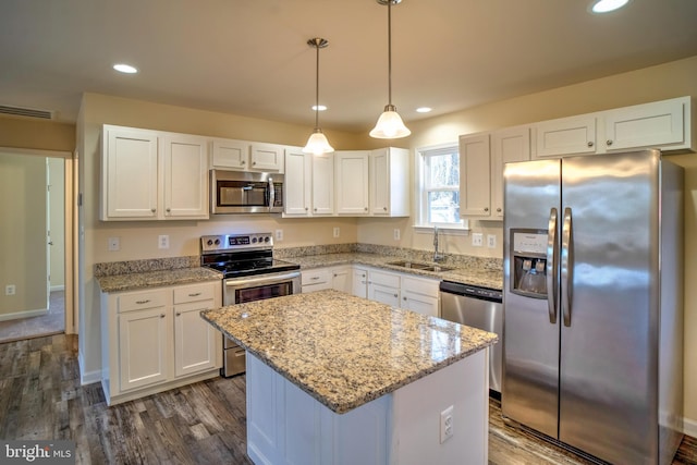 kitchen featuring white cabinetry, sink, a center island, and appliances with stainless steel finishes