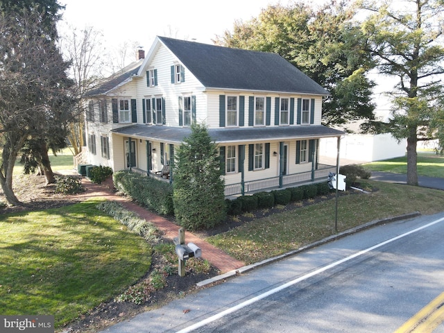 view of front facade with a front yard and a porch