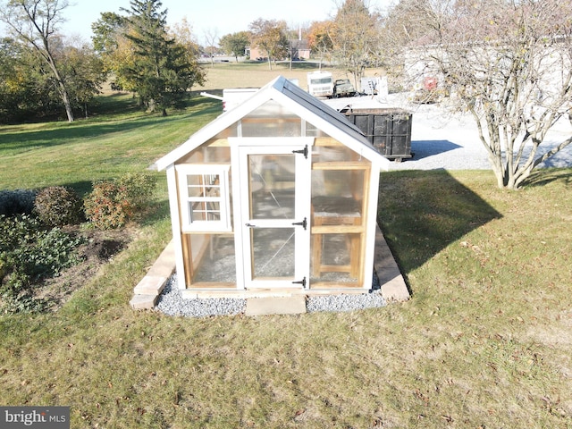 view of outbuilding with a lawn