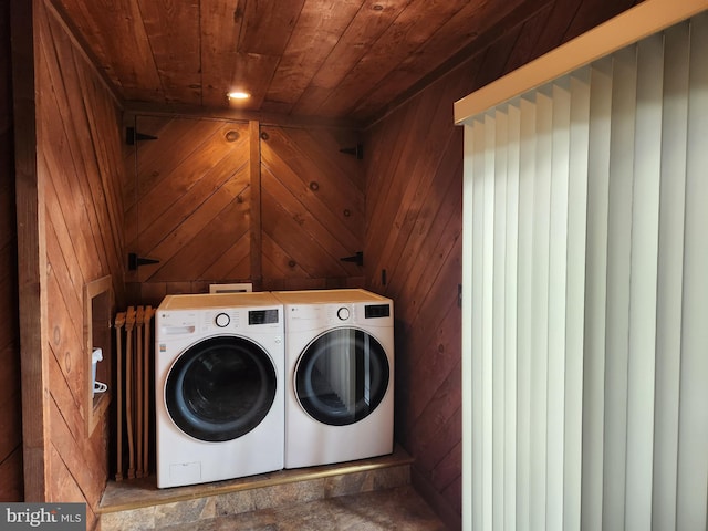 washroom with washer and dryer, wooden ceiling, and wooden walls