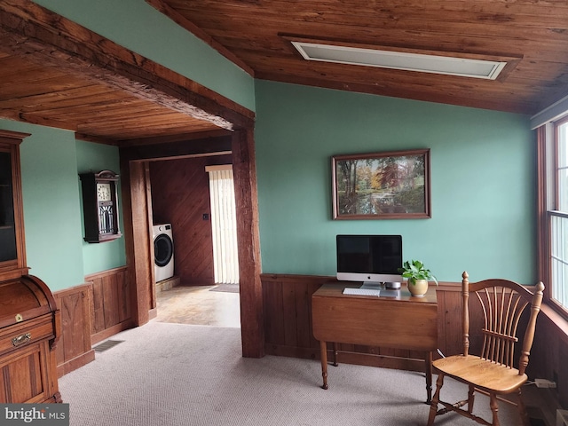 office area featuring washer / dryer, light colored carpet, wood ceiling, and wood walls